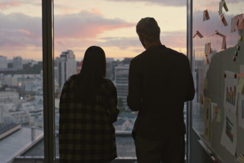 Business people silhouettes talking at dusk workplace close up. Team discussing