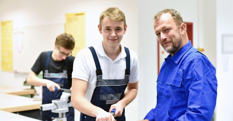 Group of young people in technical vocational training with teacher